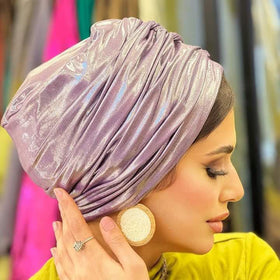 A woman with a purple turban on her head.