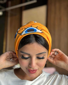 Woman with blue and yellow turban, traditional design.