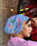 A woman wearing a colorful printed turban, adding vibrancy and style to her overall appearance.