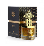 A perfume bottle placed in front of a black box.
