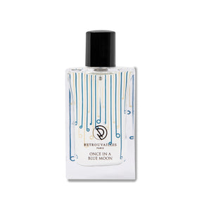 A bottle of perfume on a white surface.