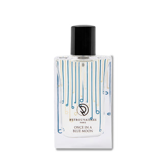A bottle of perfume on a white surface.