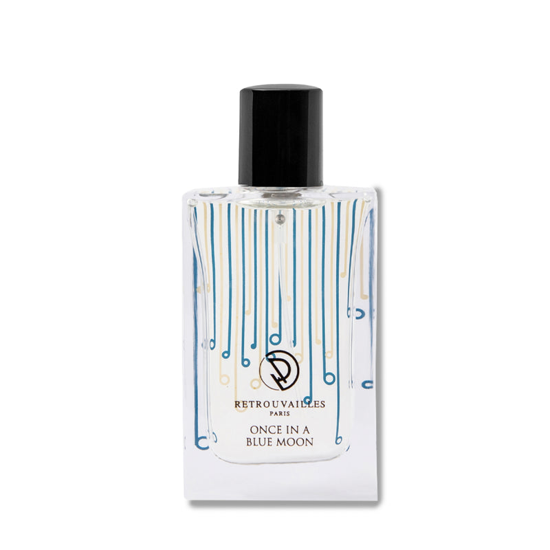 A bottle of perfume on a white surface.