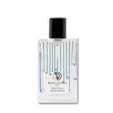 A bottle of perfume on a white surface.